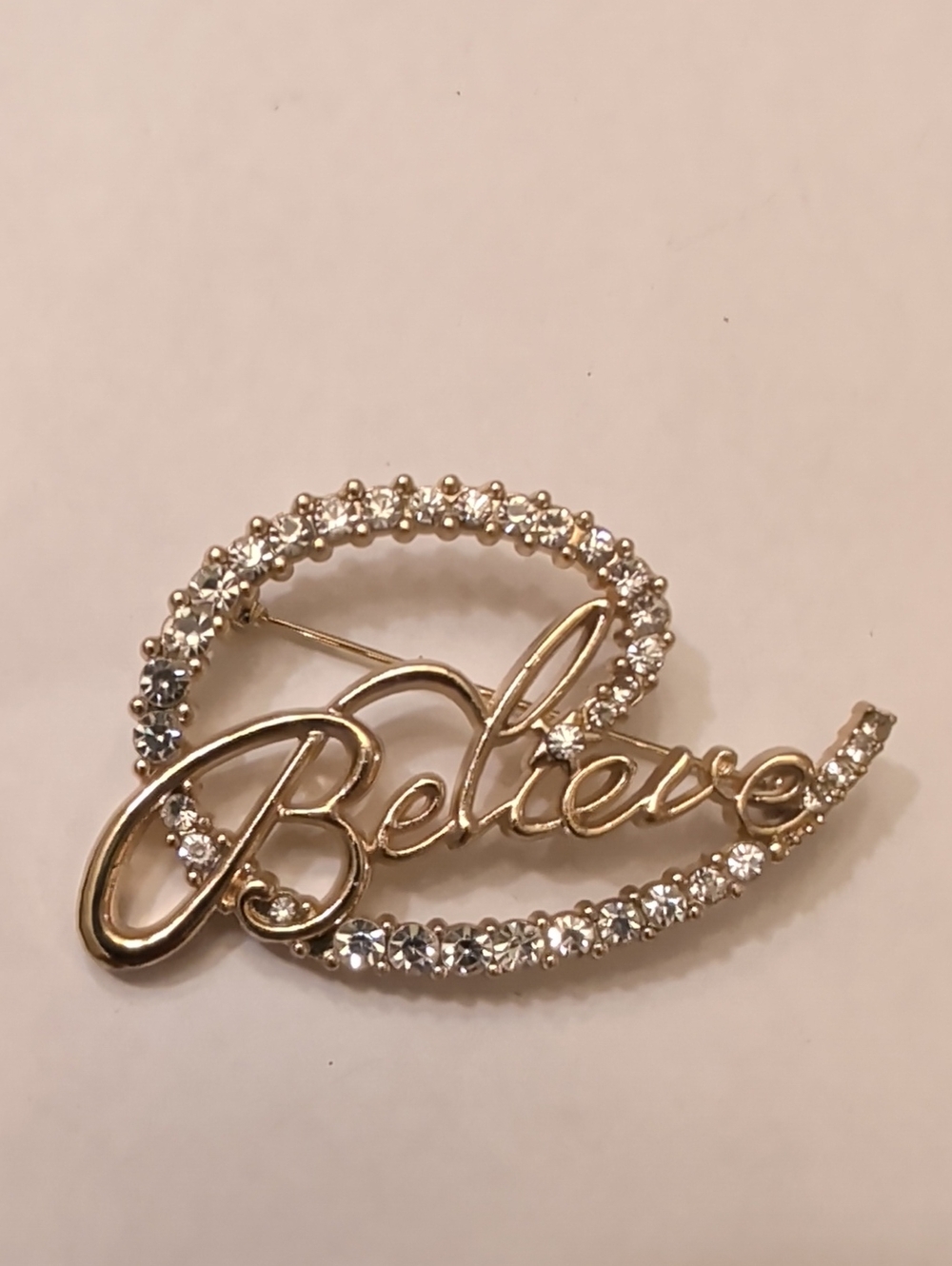Gold 'Believe' Script Brooch with Clear Crystals